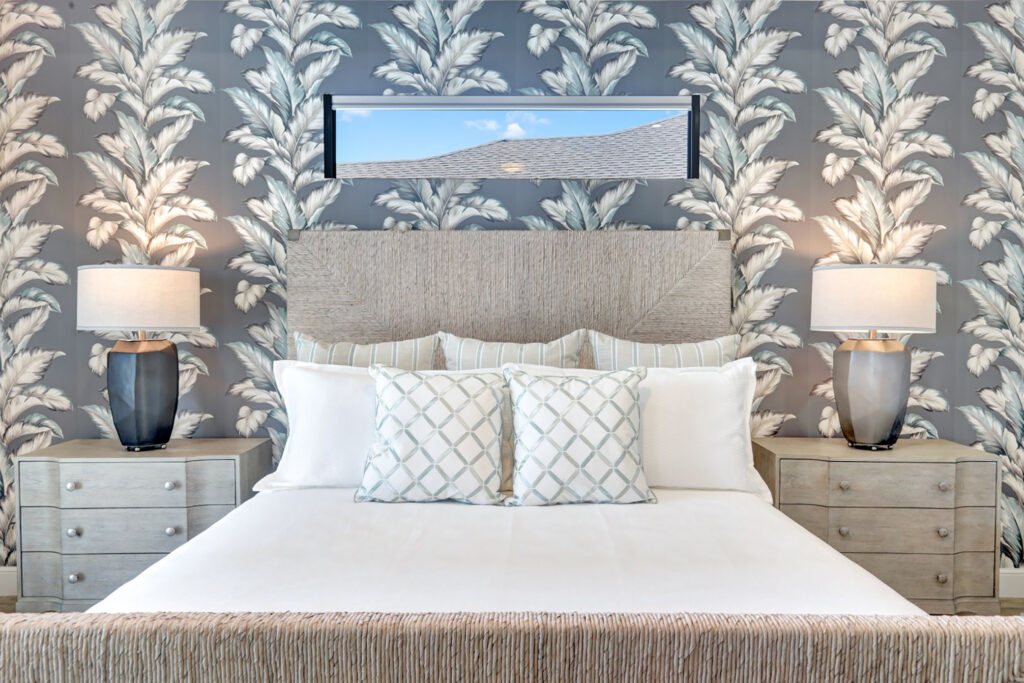 Leaf-patterned wallpaper in guest bedroom